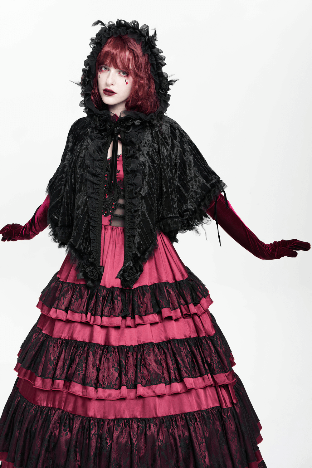 Black Gothic Hooded Lace Cape with Rose Details worn with a dramatic pink layered skirt and gloves, showcasing dark elegance.