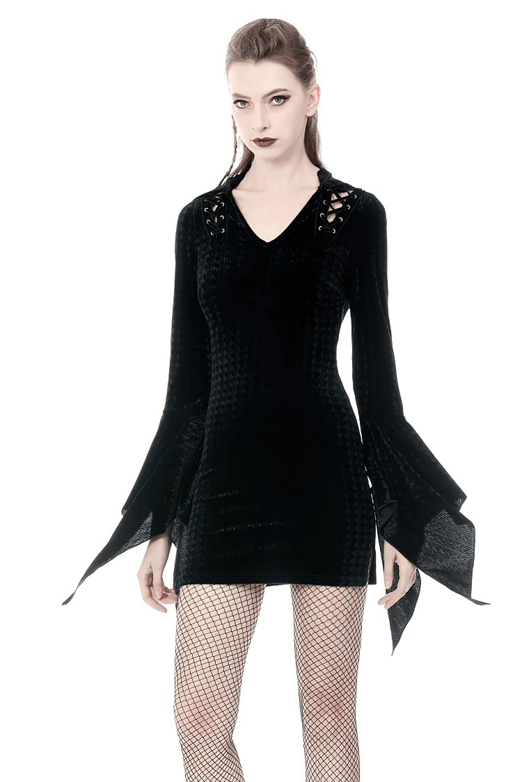 Model wearing a black gothic hooded mini dress with lace-up detail and bell sleeves, perfect for dark fashion lovers.