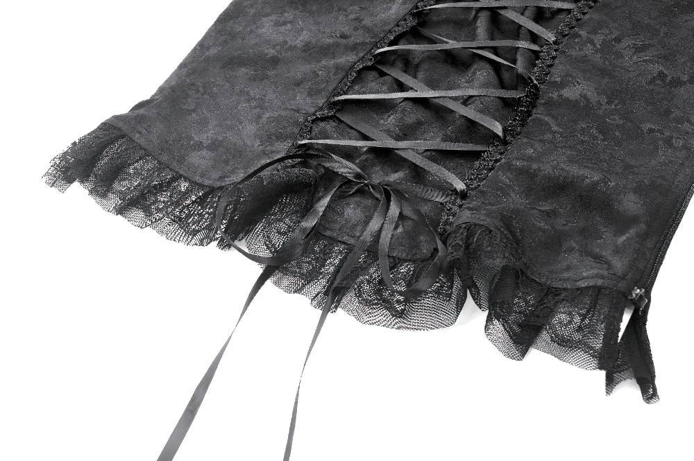 Close-up of black gothic jacquard corset with lace trim and satin back lacing, showcasing intricate frills and ribbons.