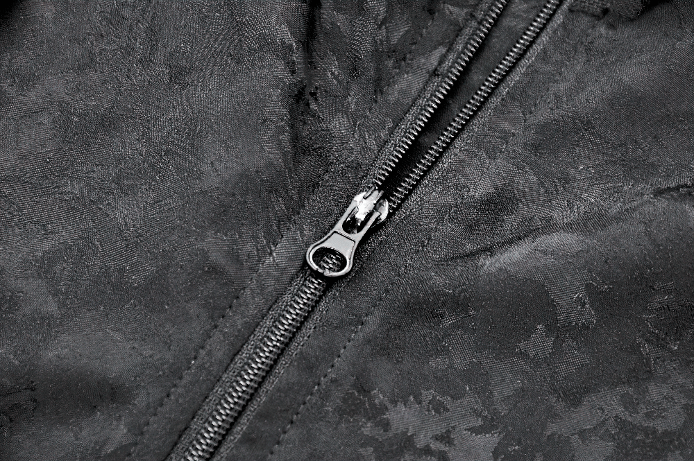 Close-up of zipper on black gothic jacquard top with intricate fabric detail.