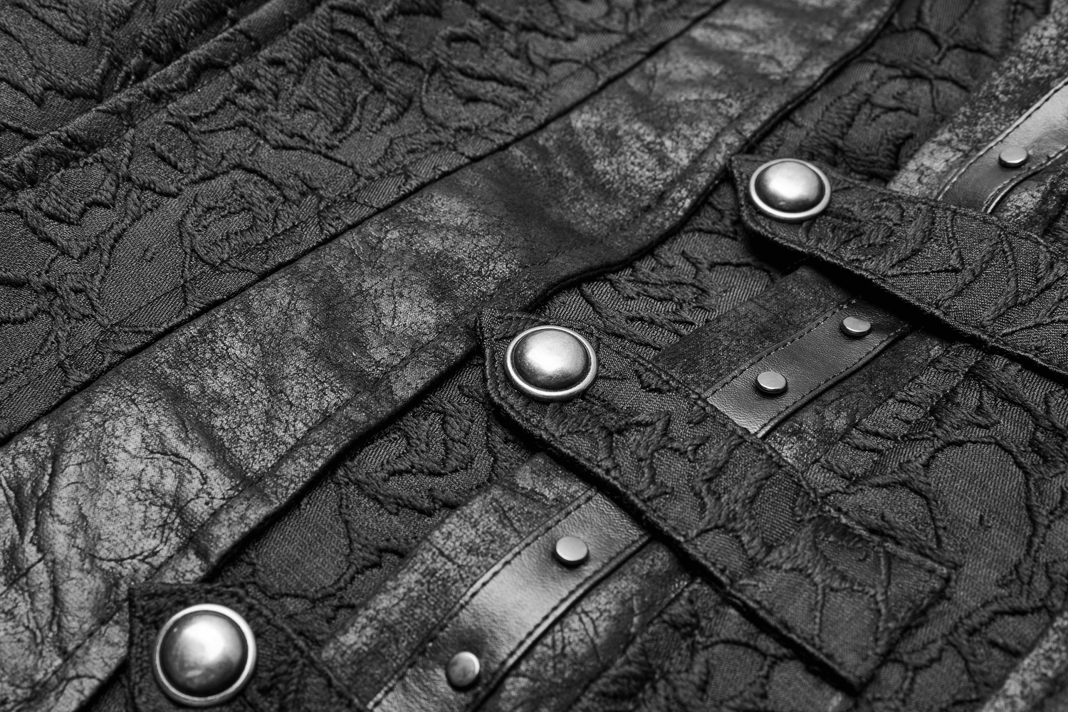 Close-up of a black gothic jacquard waistcoat showcasing textured fabric and buckle accents for a punk-inspired look.