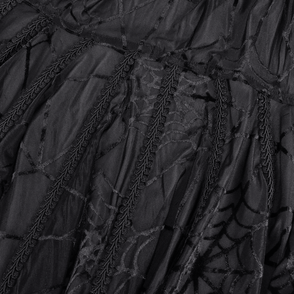 Close-up of black gothic lace cape featuring intricate spiderweb pattern and flowing tassels, perfect for Halloween.