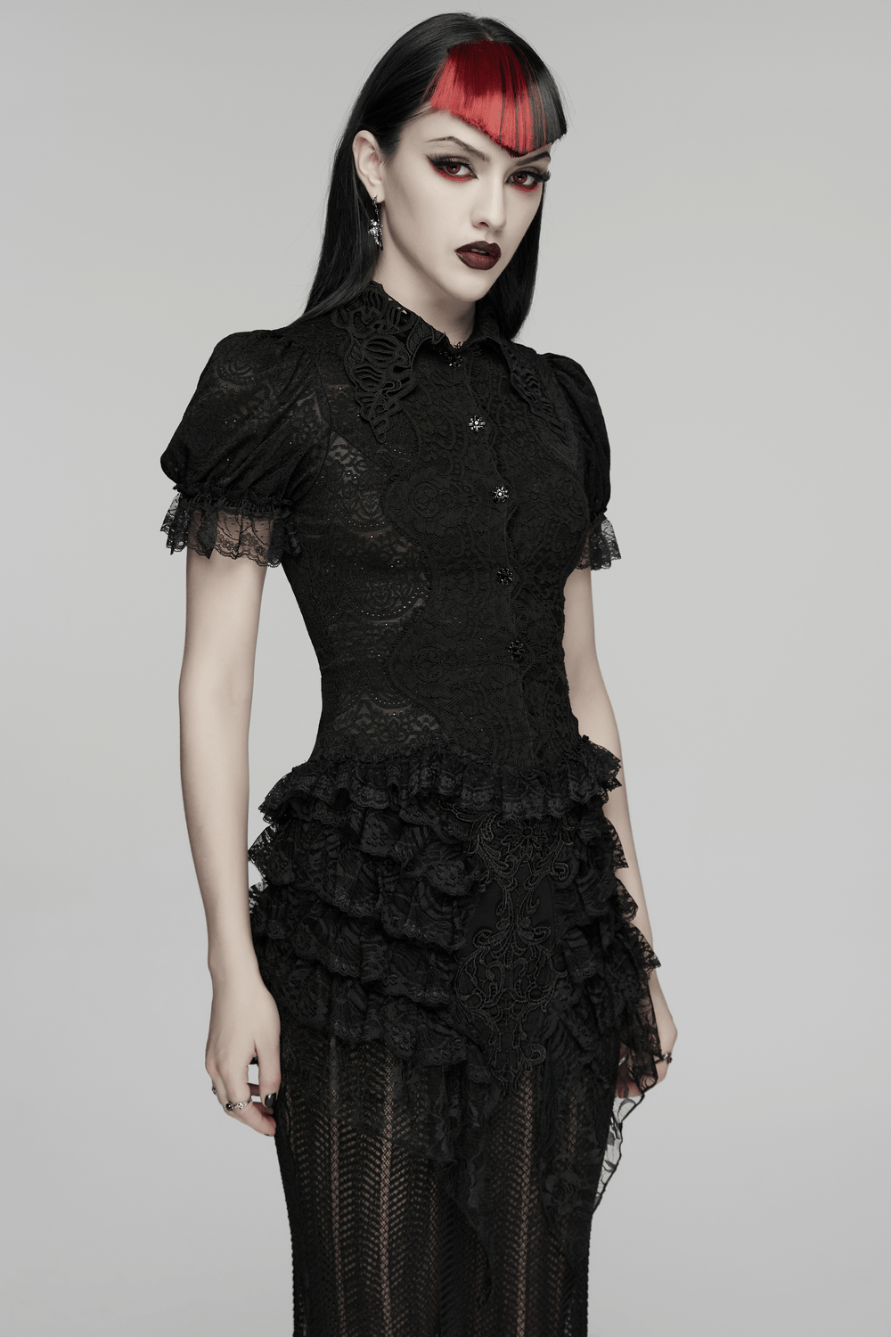 Alt Tag: Black Gothic Lace Corset Blouse with Puff Sleeves worn by model, sheer floral lace, puff sleeves, Victorian buttons, ruffled trim