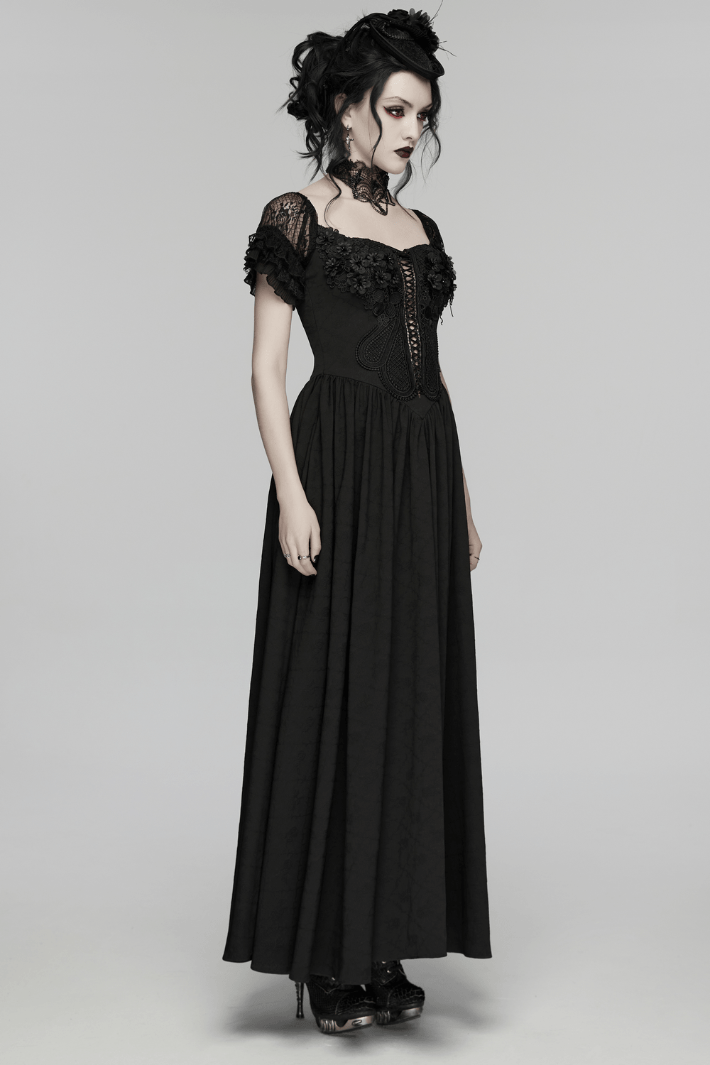 Alt Tag: Black Gothic Lace Corset Maxi Dress with Victorian Style on model, V-neck lace sleeves, corset front, dramatic Victorian goth maxi silhouette