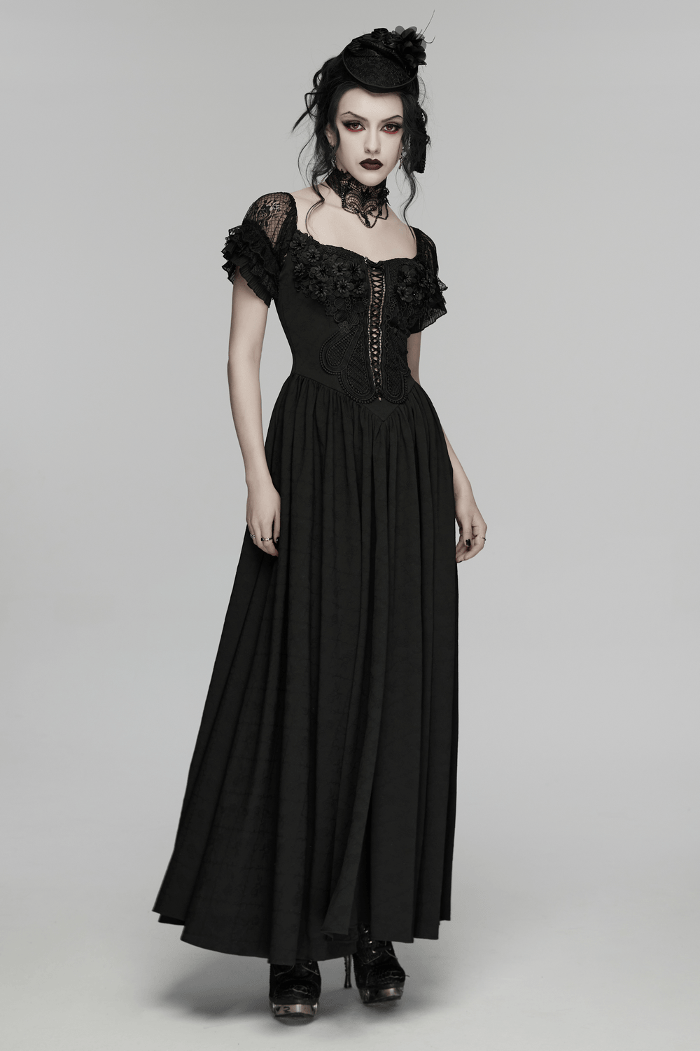 Alt Tag: Black Gothic Lace Corset Maxi Dress with Victorian Style on model, V-neck corset bodice, short lace sleeves, flowing maxi skirt