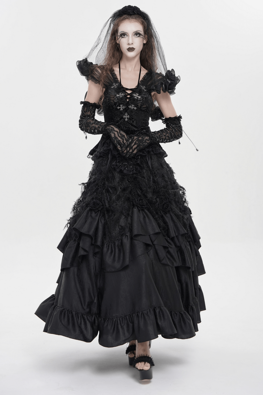 Black Gothic Lace Corset Top with Sheer Ruffle Sleeves on model, floral applique, cross accents, lace-up bodice with dramatic ruffle detail