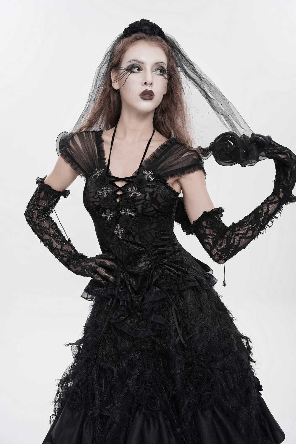 Alt Tag: Black Gothic Lace Corset Top with Sheer Ruffle Sleeves worn with lace gloves, cross accents, and dramatic black veil gothic look
