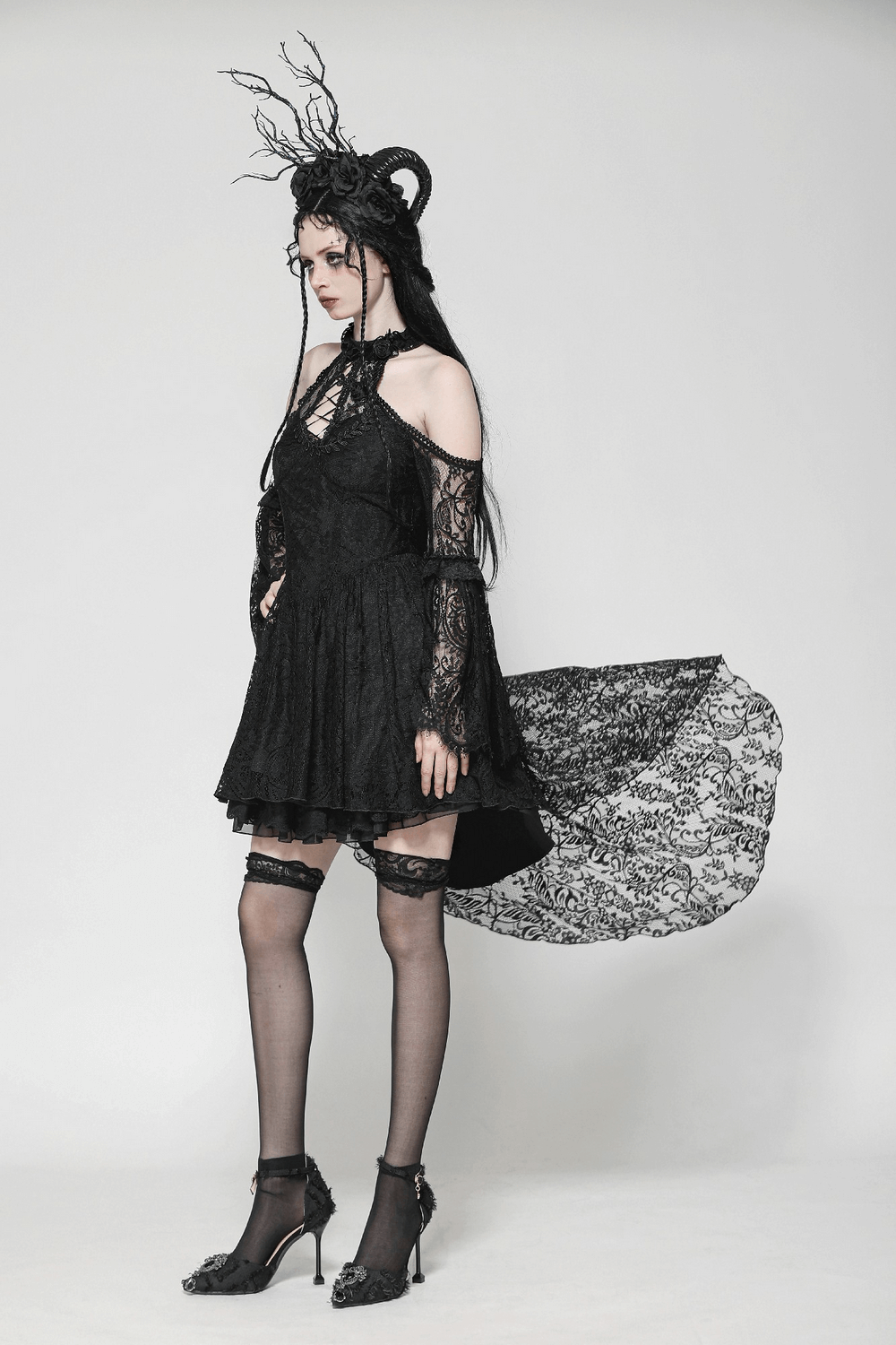 Gothic lace cutout dress with heart detail, ruffles, and open shoulders, styled with elegant black accessories.