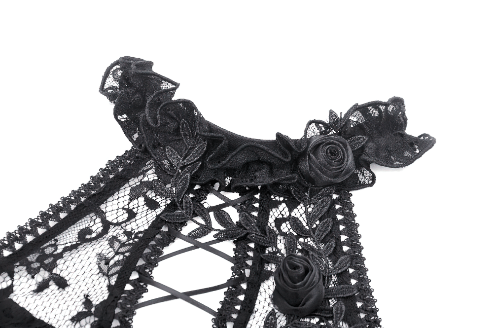 Close-up of black gothic lace dress featuring ruffled collar and rose embellishments, perfect for edgy elegance.