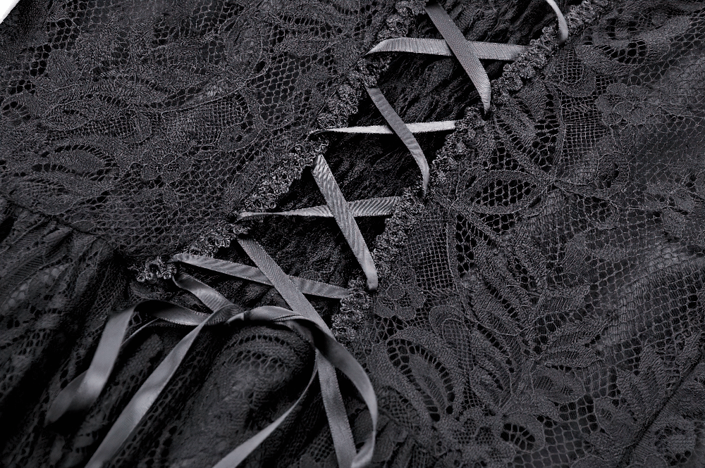 Close-up of black gothic lace dress with intricate lace pattern and lace-up back details, highlighting romantic style.