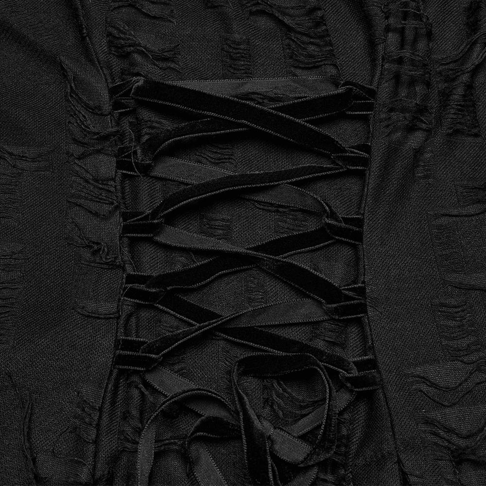 Close-up of black lace detailing and eyelets on a gothic dress with asymmetric hem.