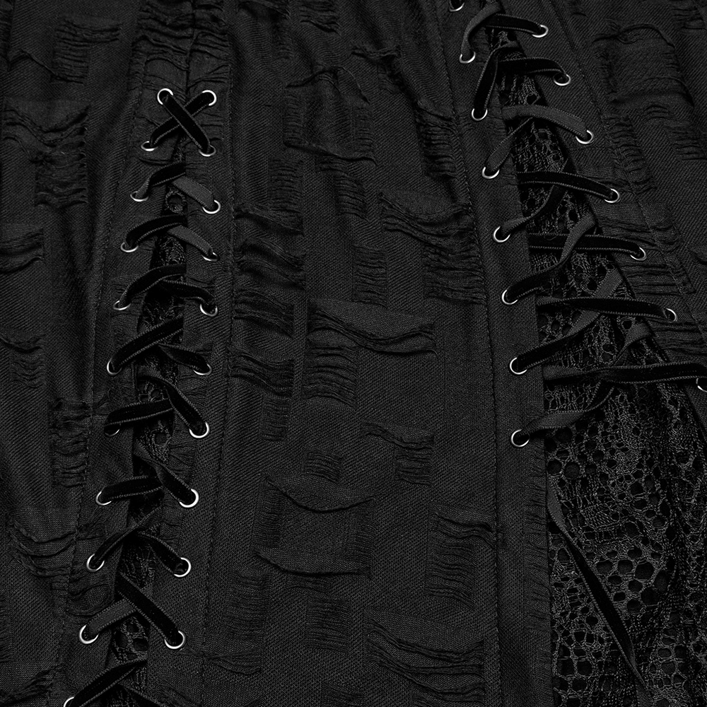 Close-up of black gothic lace dress with asymmetric hem and eyelets, showcasing intricate lace and lace-up details.