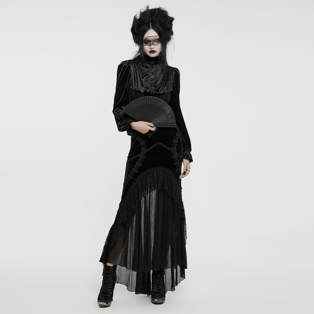 Elegant model in black gothic lace fishtail skirt with sheer chiffon panels and a fan, embodying gothic fashion.