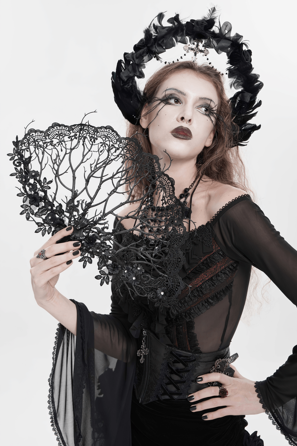 Alt Tag: Black Gothic Lace Hand Fan with Floral Branch Detail held by model in Victorian dark romance outfit, ornate floral filigree lace fan accessory