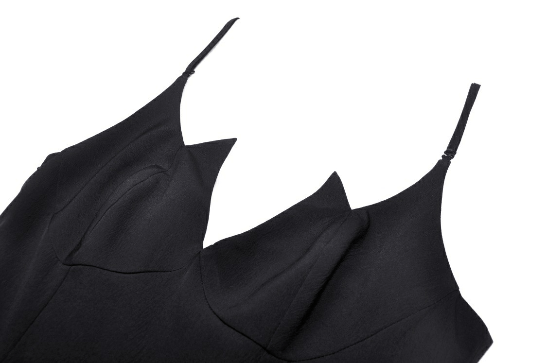 Close-up of a black Gothic lace dress featuring a plunging neckline and elegant straps.