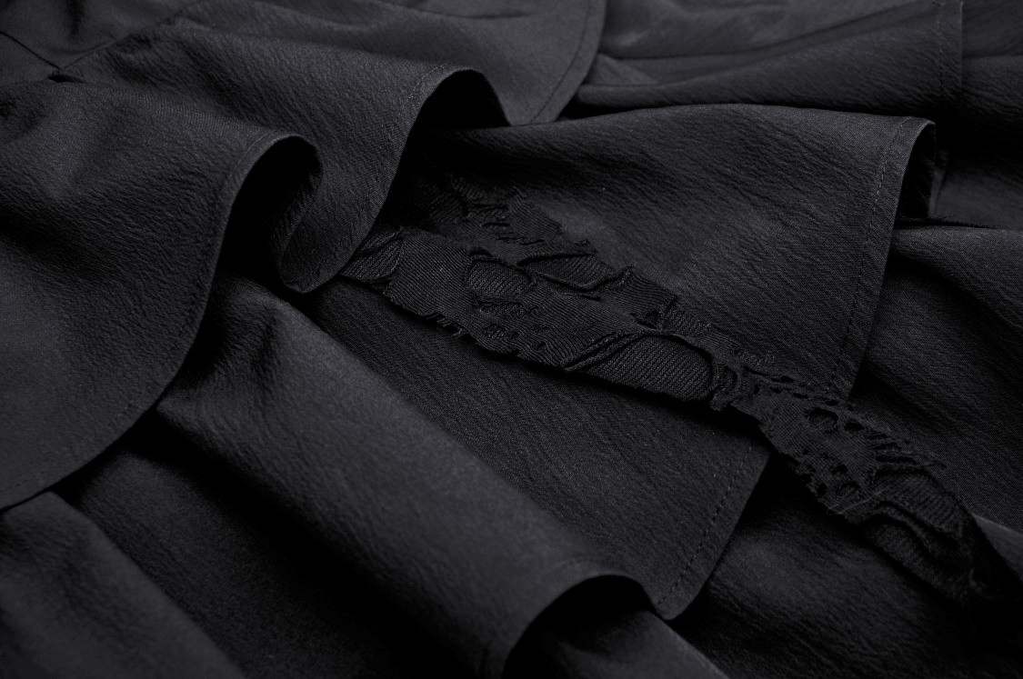 Close-up of black Gothic dress with delicate lace and layered ruffles, showcasing dark romantic texture and detail.