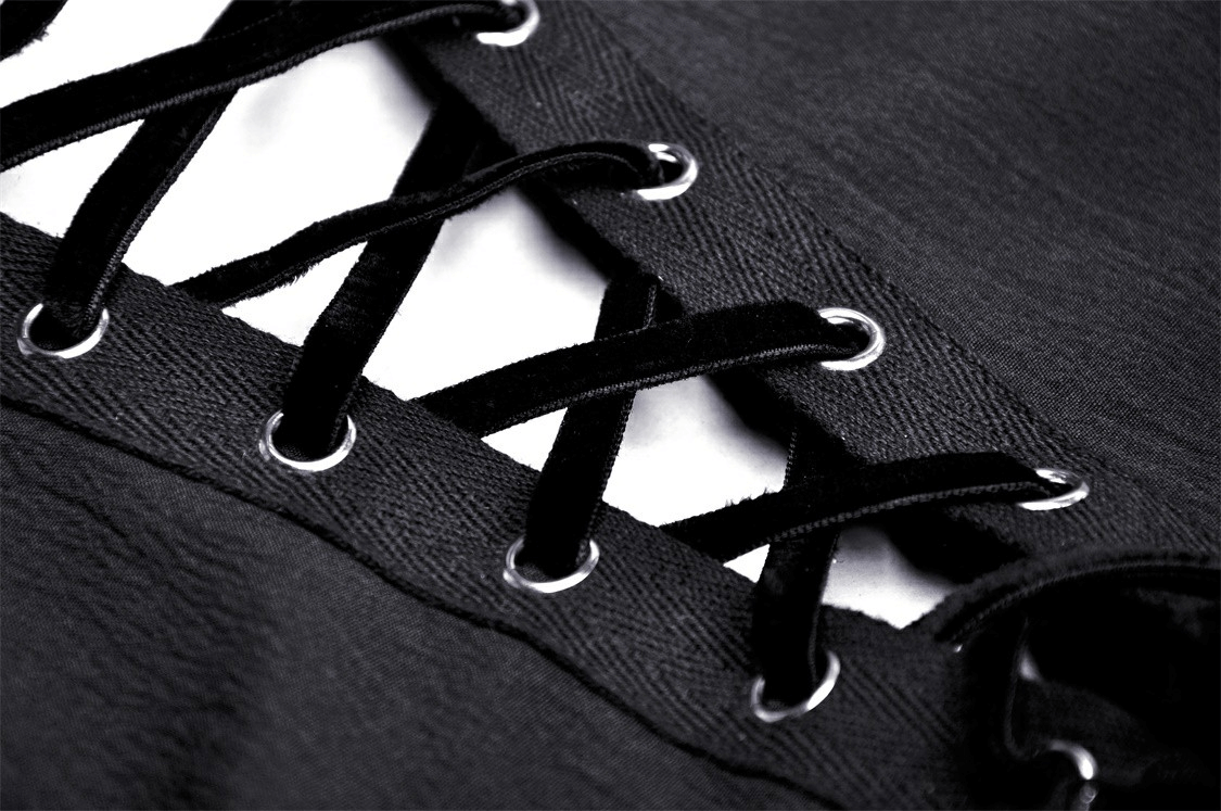 Close-up of black lace-up detailing on a Gothic dress, showcasing elegant ribbon laces and eyelets.
