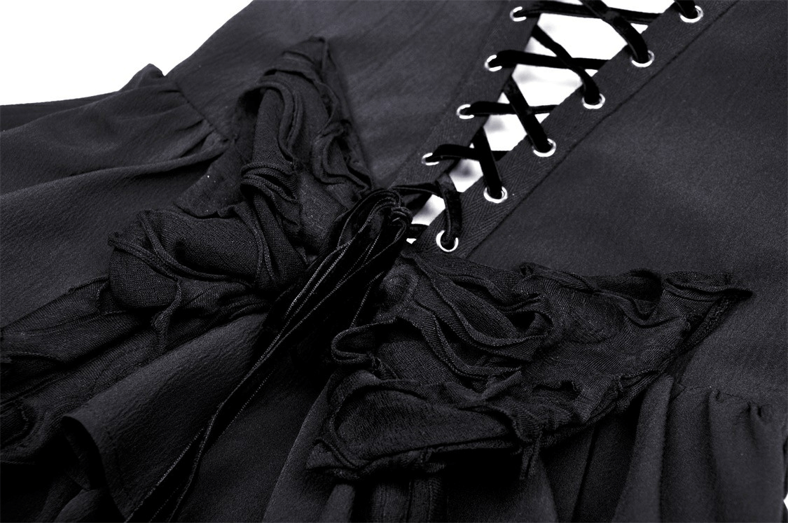 Close-up of black Gothic lace dress with plunging neckline and ruffled detailing, showcasing edgy fringe accents.