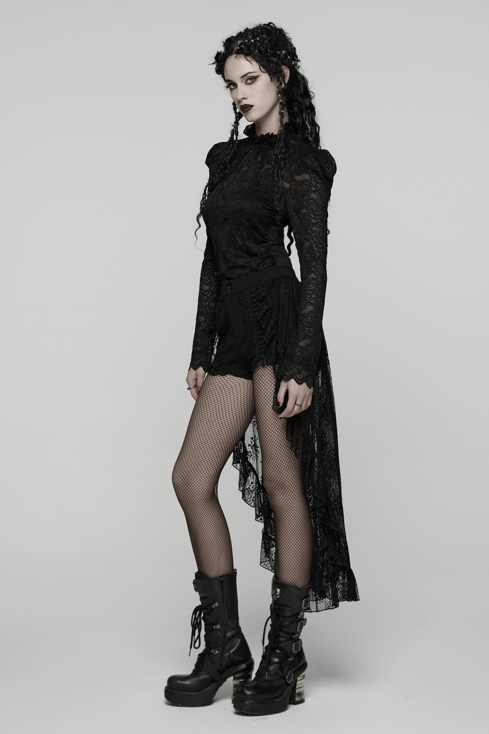 Black Gothic Lace Shorts with High-Low Ruffled Hem worn by model with lace top and fishnet stockings.