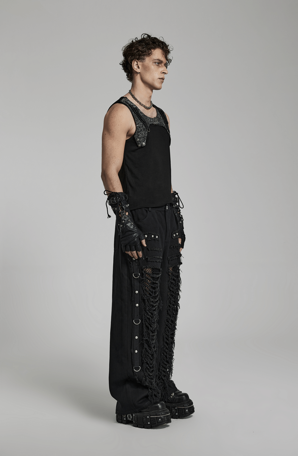 Edgy black gothic lace-up cargo pants with punk chain detail, paired with a black tank top and gloves.
