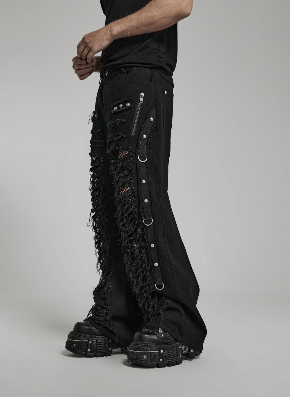 Black Gothic cargo pants with edgy ripped detail and punk chain features for men, styled for a rebellious look.