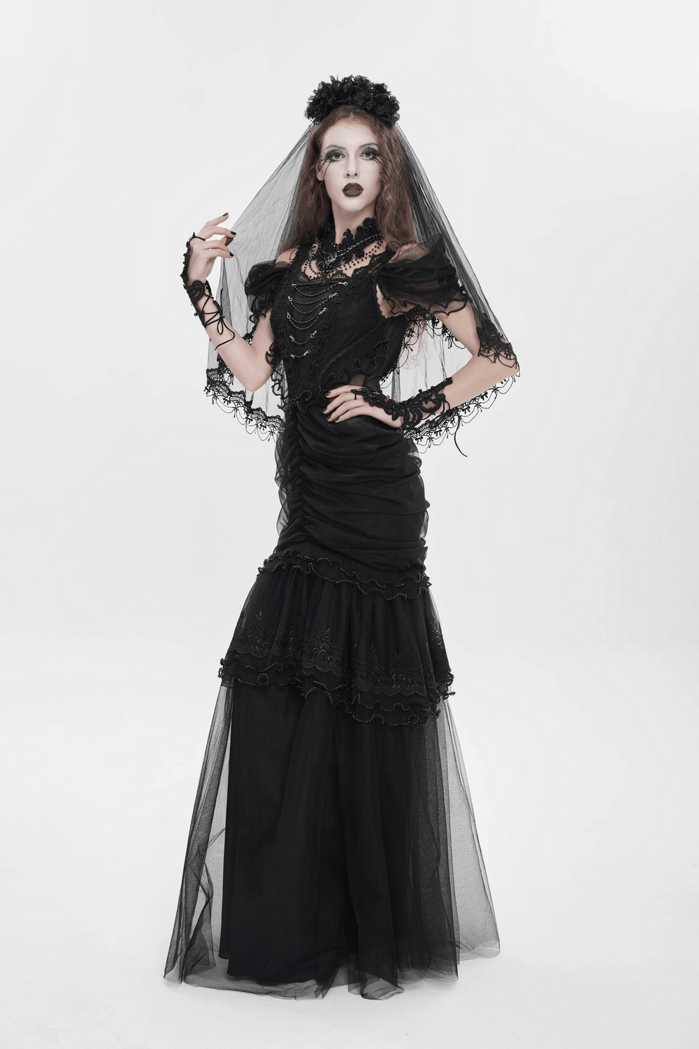 Black Gothic Lace-Up Dress with Ruffled Tulle and Roses in dramatic pose, featuring elegant lace and tulle details.