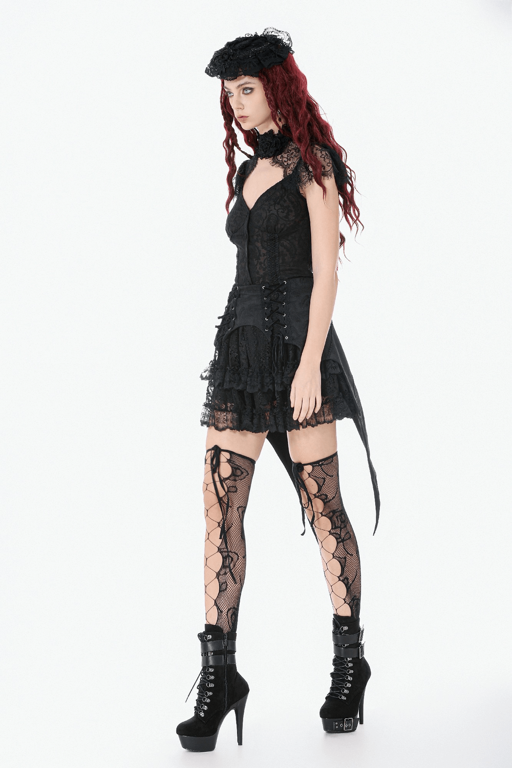 Black Gothic Lace-Up Layered High Low Bustle Skirt worn with lace stockings and platform boots, showcasing a dramatic gothic look.
