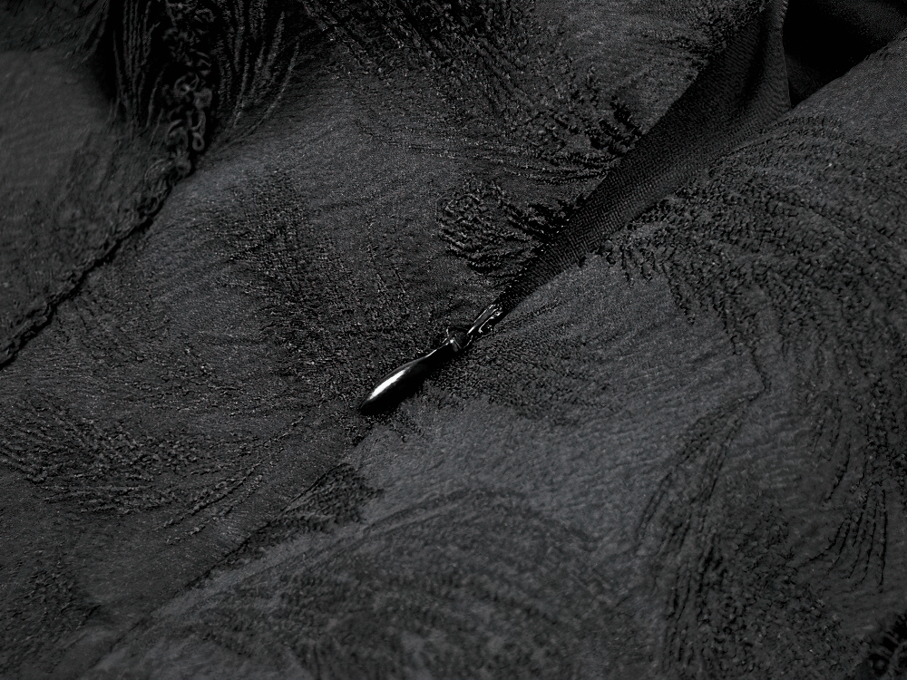 Close-up of the textured black jacquard fabric of the Black Gothic Lace-Up Layered High Low Bustle Skirt.