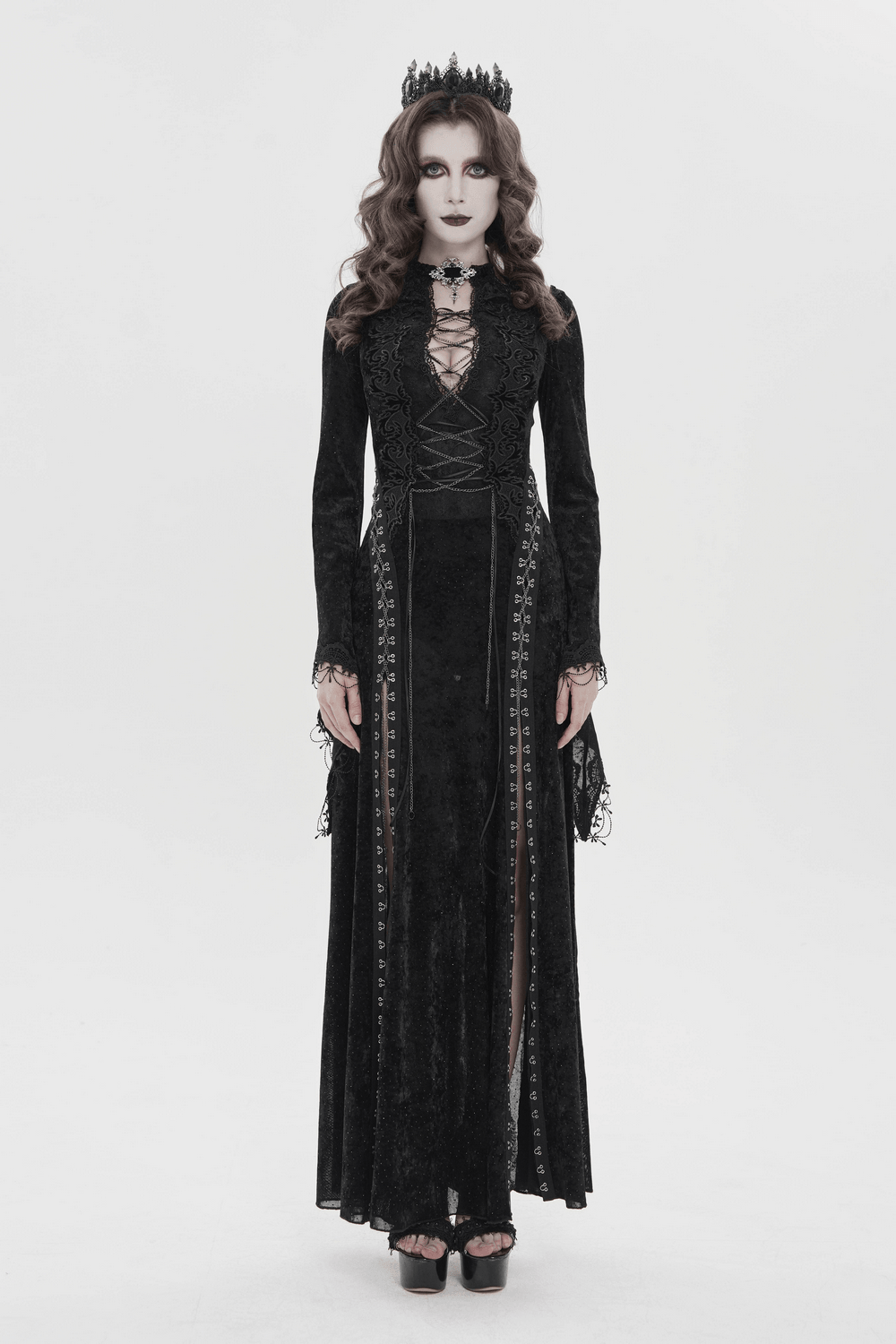Black Gothic Lace Up Maxi Dress with Bell Sleeves modeled by a woman, featuring lace details and bell sleeves.
