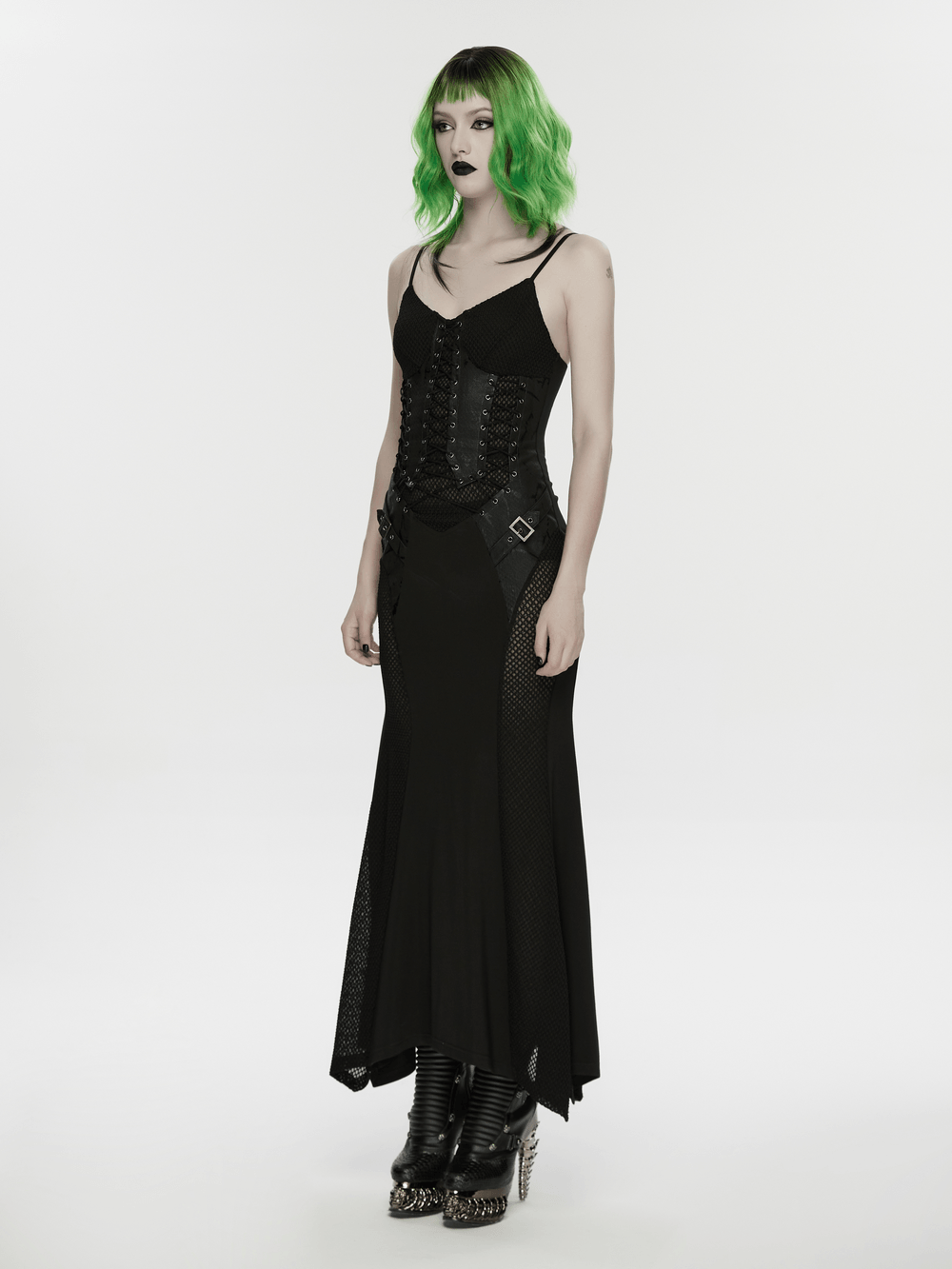 Alt Tag: Black Gothic Lace-Up Mermaid Fishnet Maxi Dress on model, corset lace-up bodice, fishnet panels, irregular hem, punk goth style