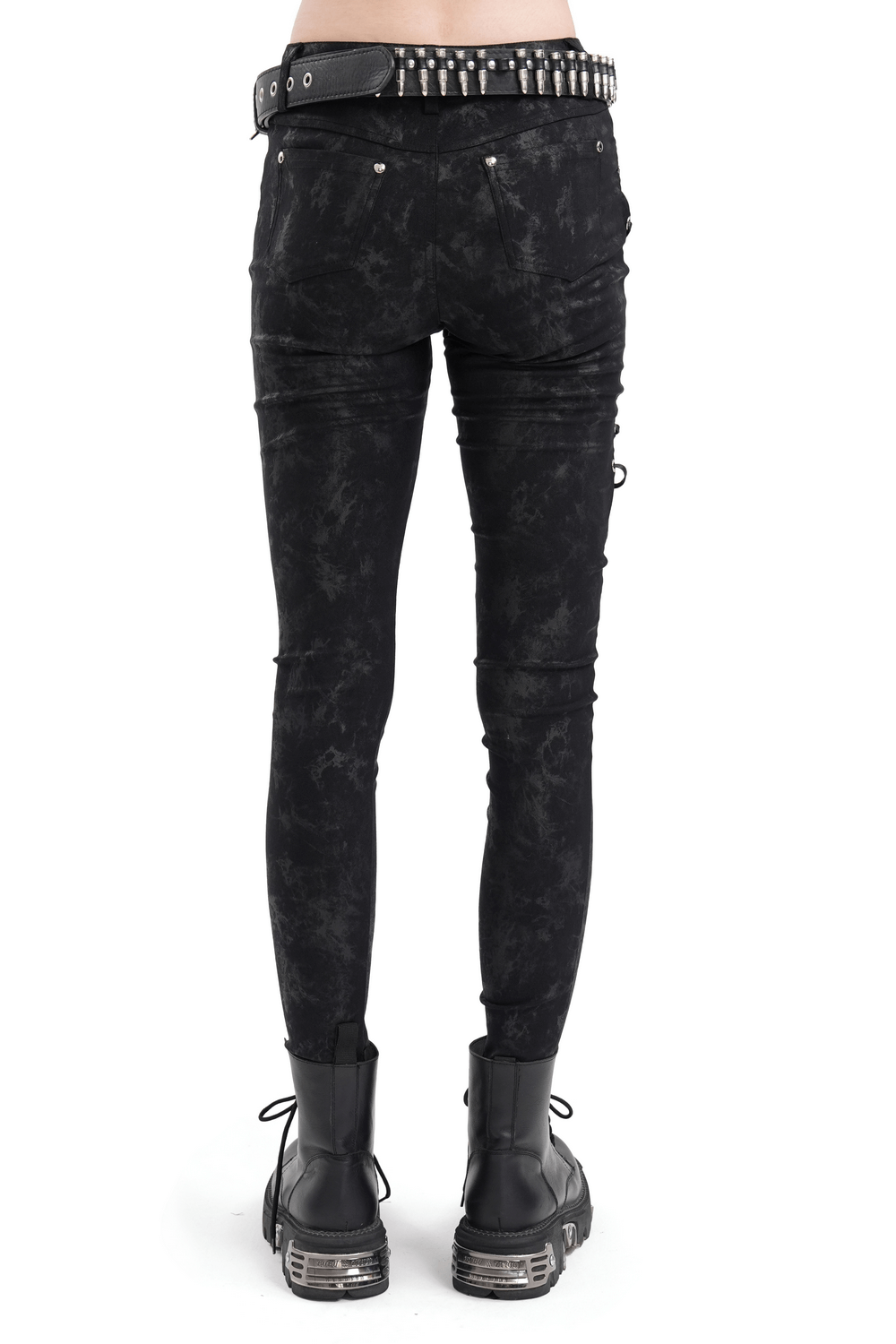 Back view of black gothic lace-up skinny pants with ripped detailing and skull accents, paired with edgy boots.