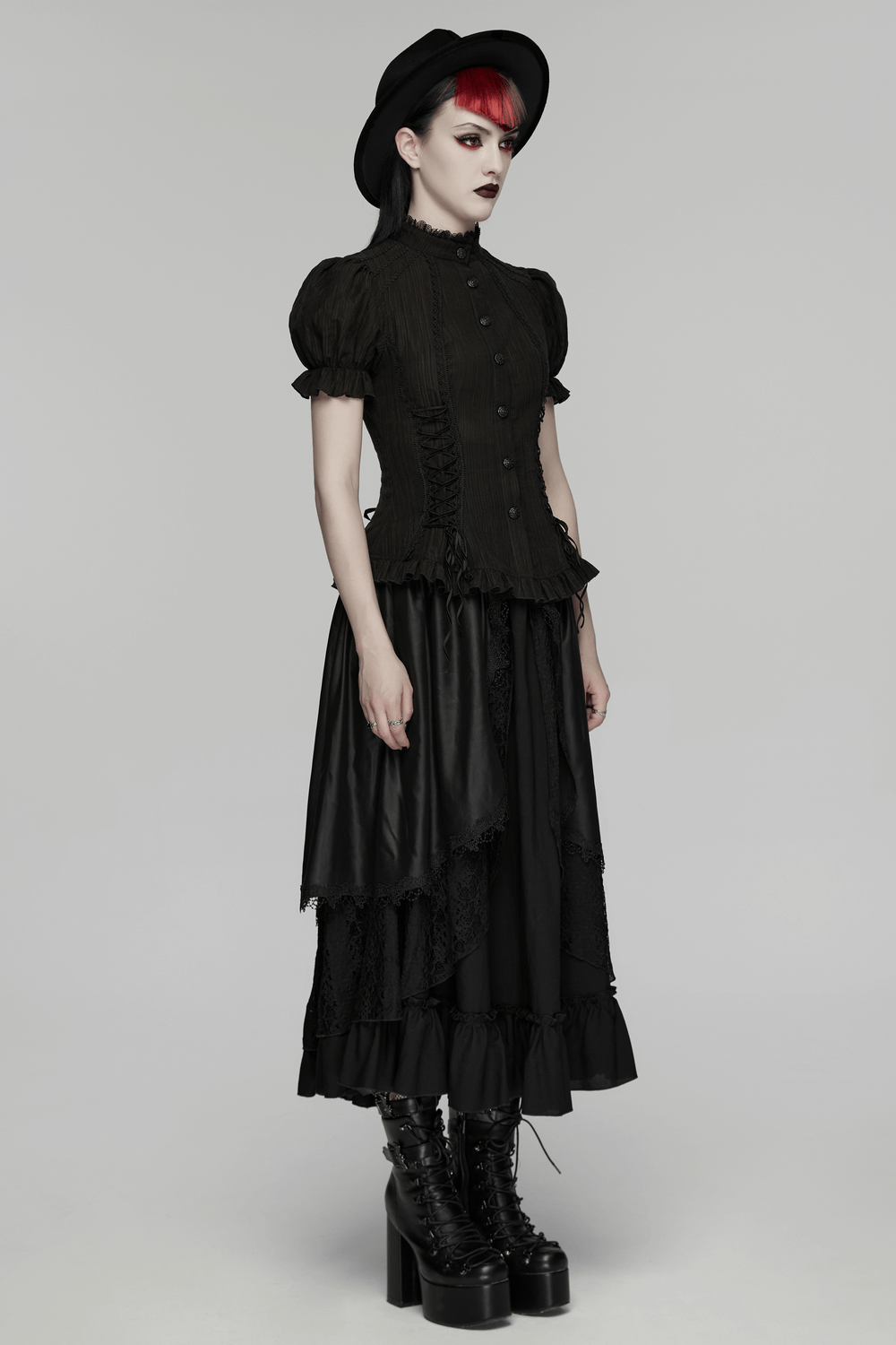 Model showcasing a Black Gothic Lace-Up Puff-Sleeved Button Shirt with a layered black skirt and platform boots.