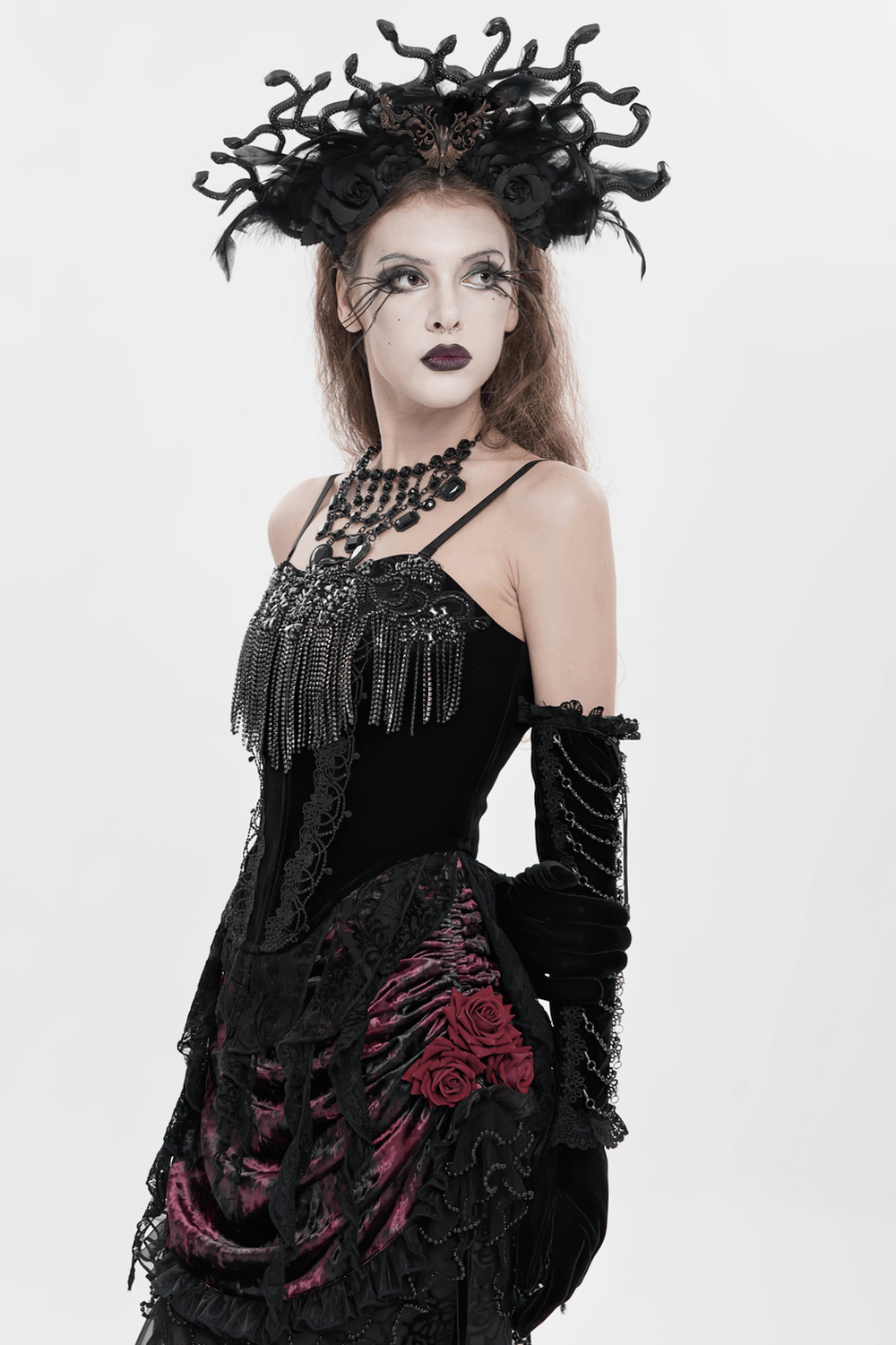 Alt Tag: Black Gothic Lace-Up Velvet Fringe Corset Top styled on gothic model in black lace dress, dramatic headpiece and dark makeup