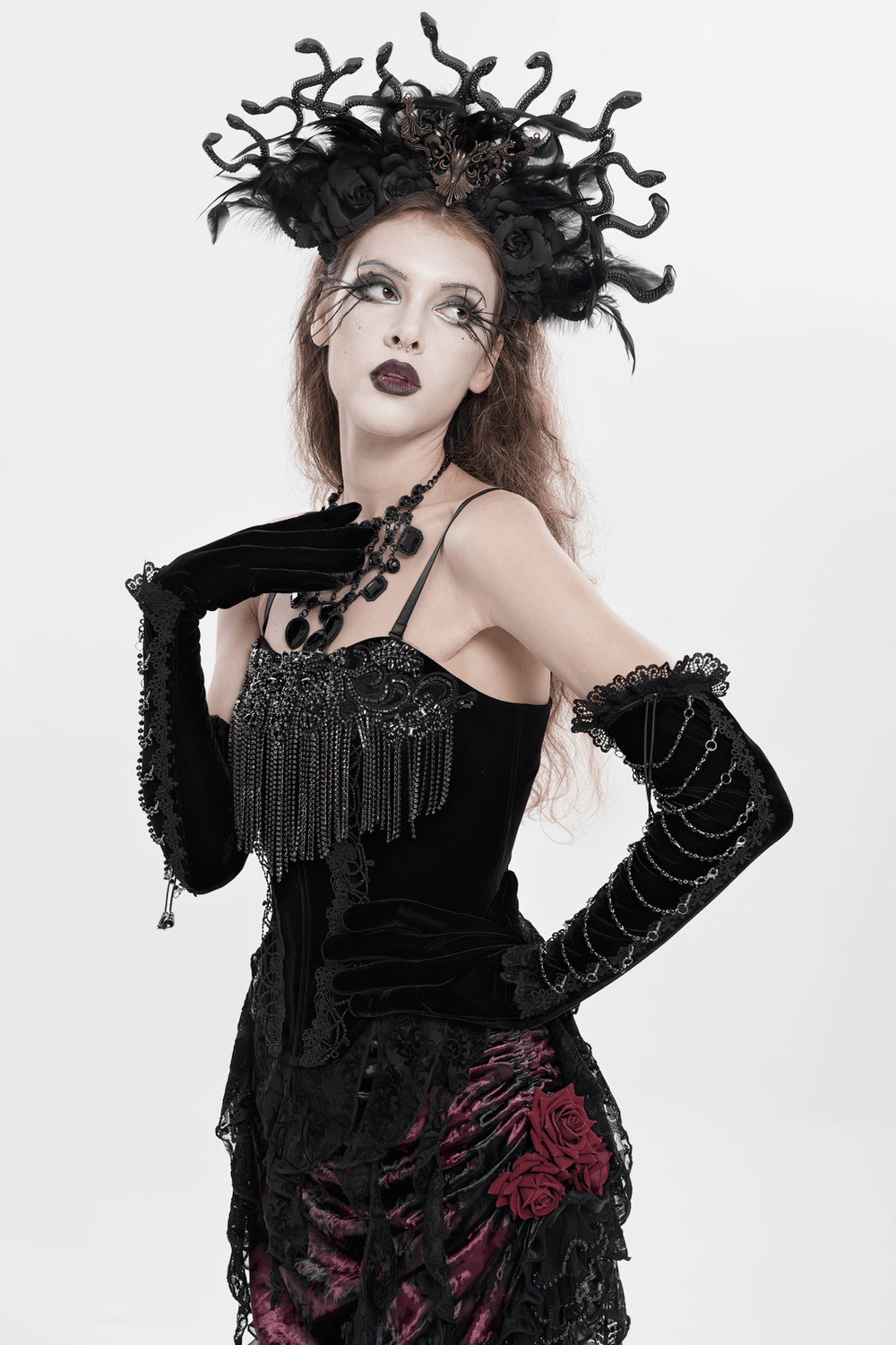 Alt Tag: Black Gothic Lace-Up Velvet Fringe Corset Top on model, black lace corset with fringe trim, dramatic gothic headpiece and gloves