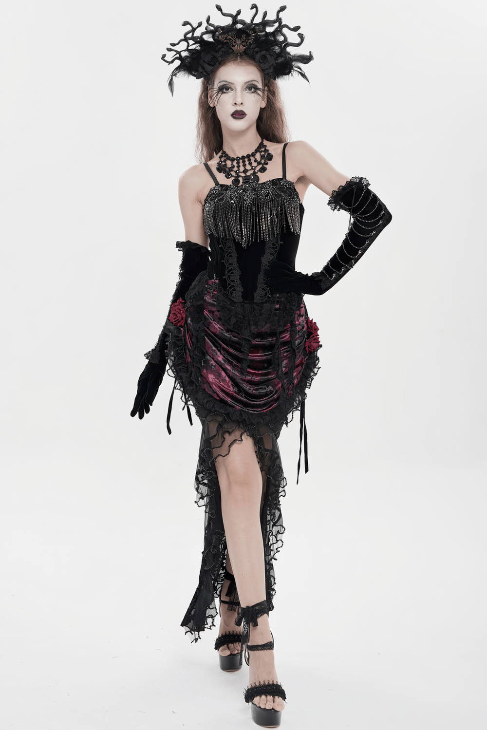 Alt Tag: Black Gothic Lace-Up Velvet Fringe Corset Top worn by model in dramatic gothic look with lace, fringe, and statement headpiece