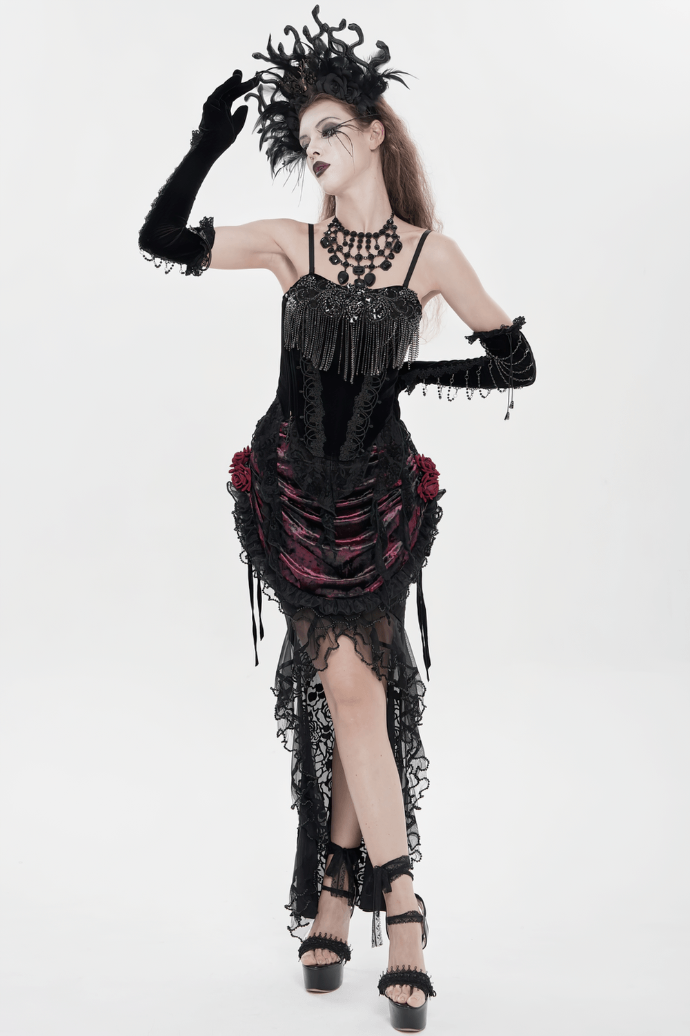 Alt Tag: Black Gothic Lace-Up Velvet Fringe Corset Top on model in black lace fringe dress, dramatic headpiece, studio white background