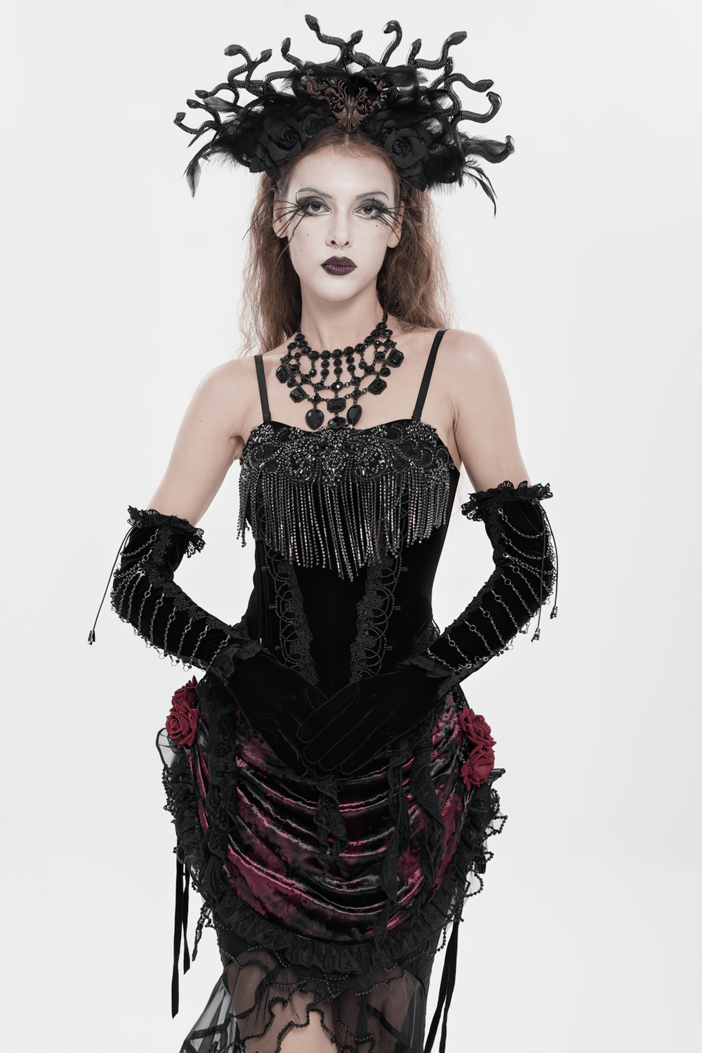 Alt Tag: Black Gothic Lace-Up Velvet Fringe Corset Top on model in dramatic gothic look, black fringe corset with lace-up detail and statement headpiece