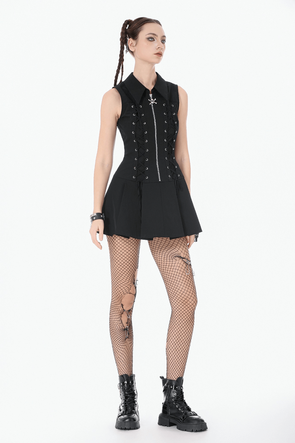 Black Gothic Lace Up Zip Front Pleated Mini Dress worn with fishnet tights and combat boots, showcasing a bold goth look.