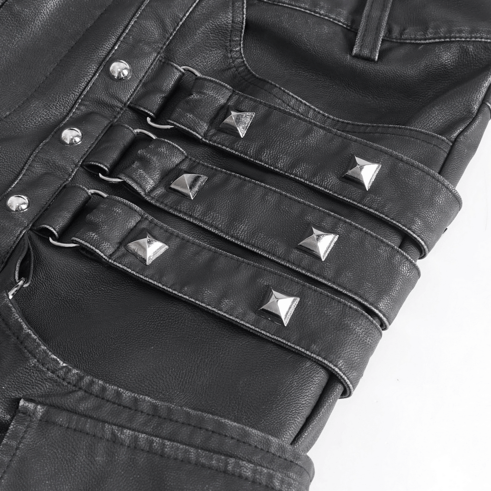 Close-up of black leather pants with silver buckles and studs, showcasing punk and gothic style details.
