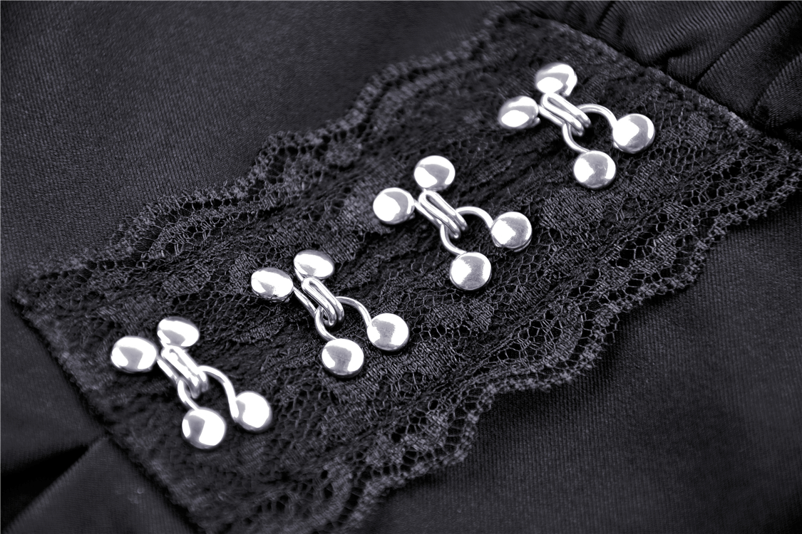 Close-up of silver clasps and lace detailing on a black gothic lolita dress featuring Victorian style elements.