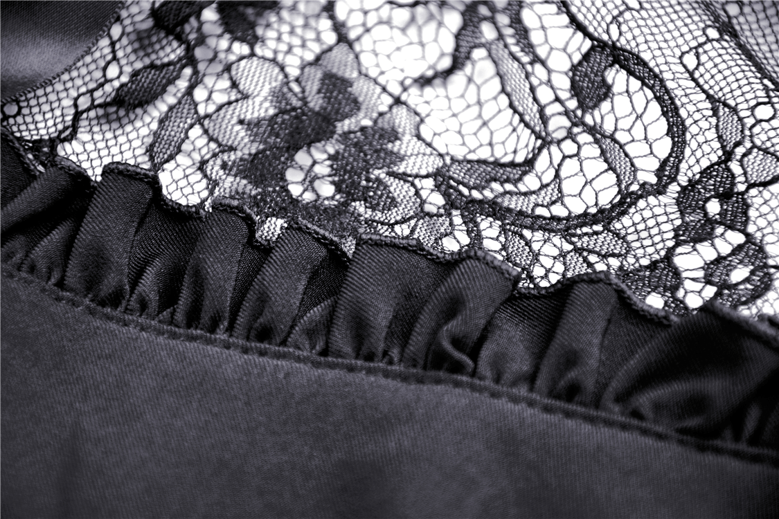 Close-up of black lace detailing and ruffled hem on a gothic lolita dress, showcasing intricate Victorian-inspired design.