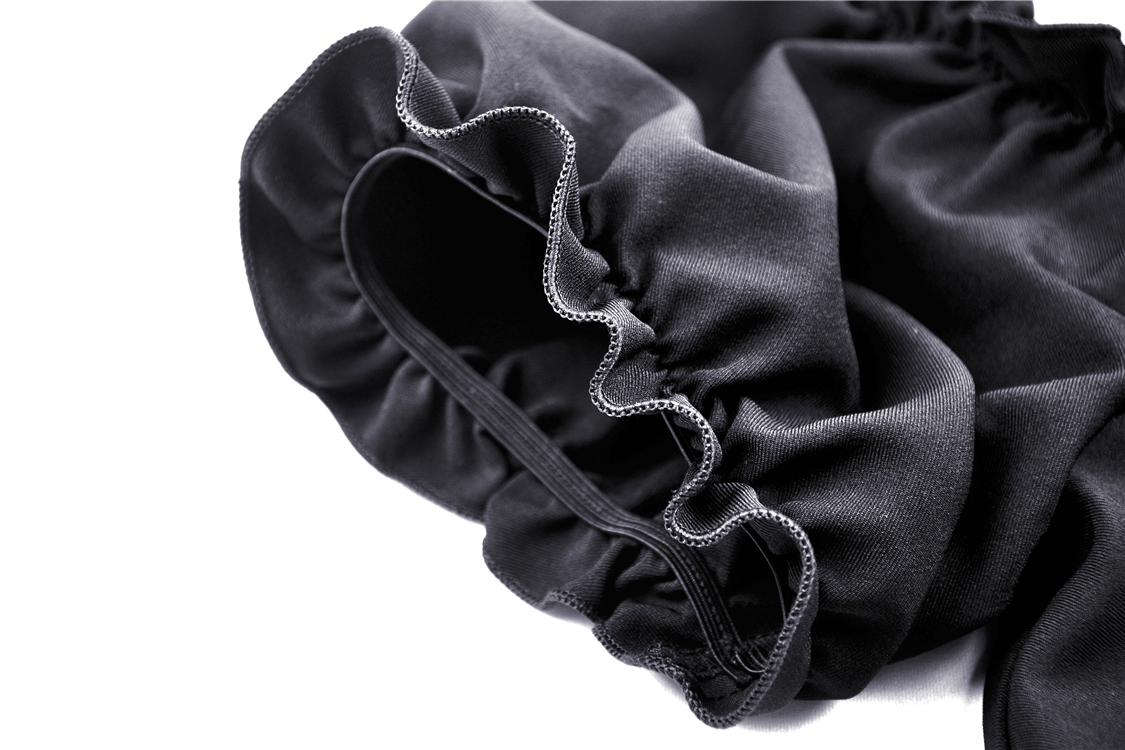 Close-up of the ruffled black fabric with elastic hem, showcasing elegant texture and style details.
