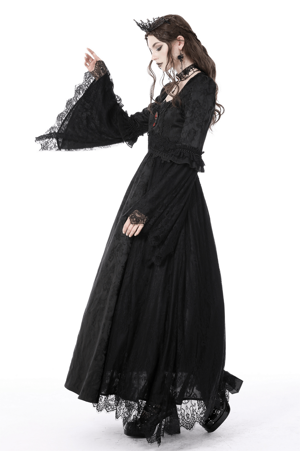 Elegant woman in black gothic long sleeves lace maxi dress with red brooch, embodying Victorian romance.