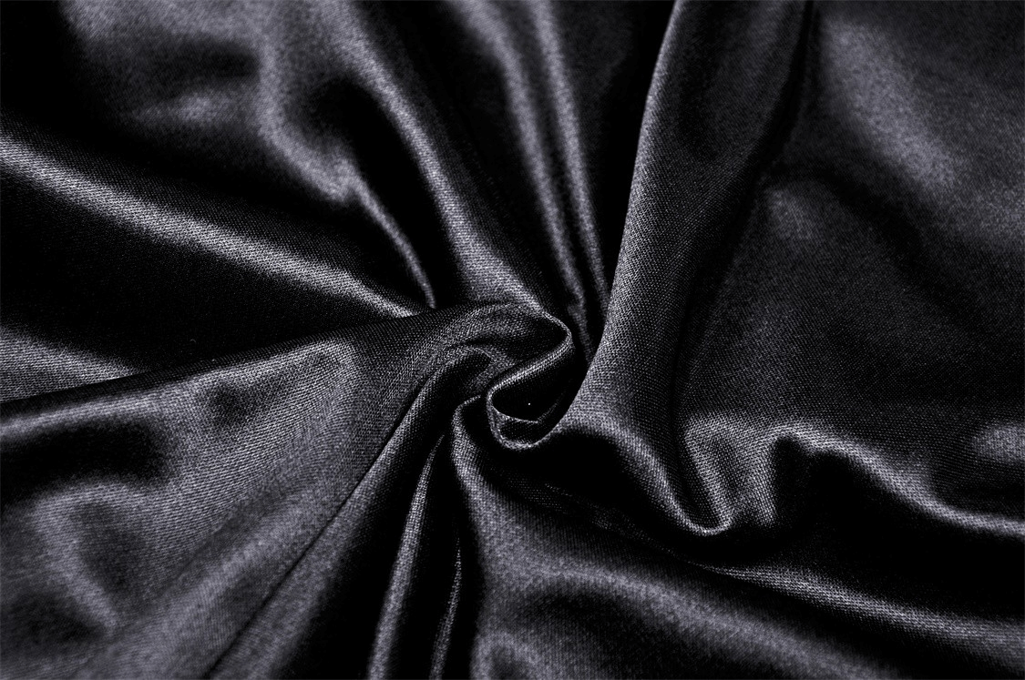 Close-up of luxurious black satin fabric, showcasing its smooth texture and elegant shine.