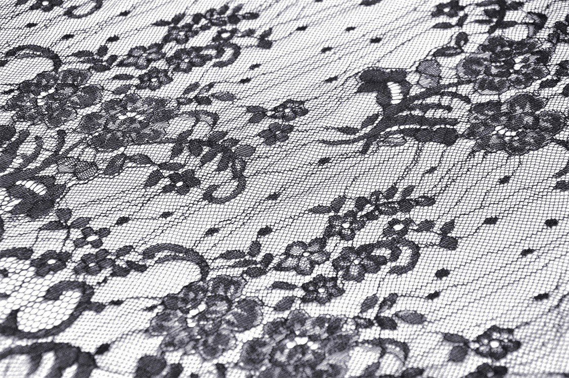 Intricate black lace fabric featuring floral patterns, perfect for gothic and Victorian-inspired fashion.