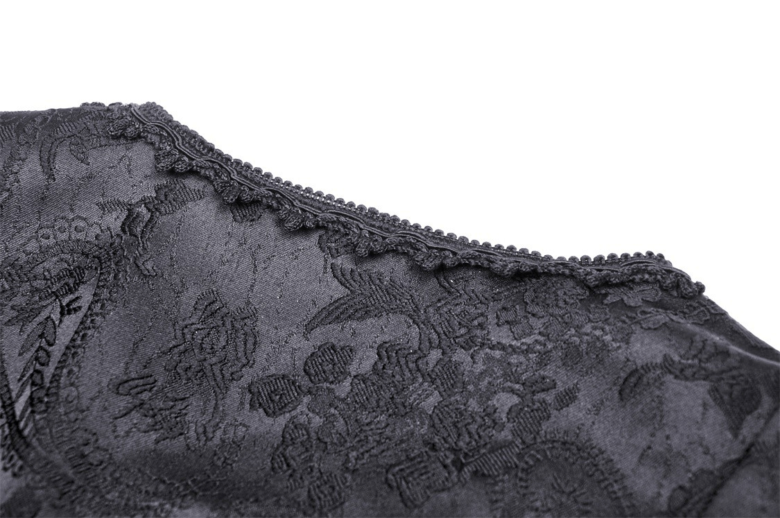 Close-up of intricate black lace detailing on the neckline of a gothic maxi dress.