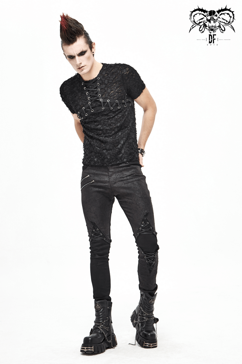 Model wearing a black gothic men's slim fit t-shirt with lace-up neckline and distressed black pants.
