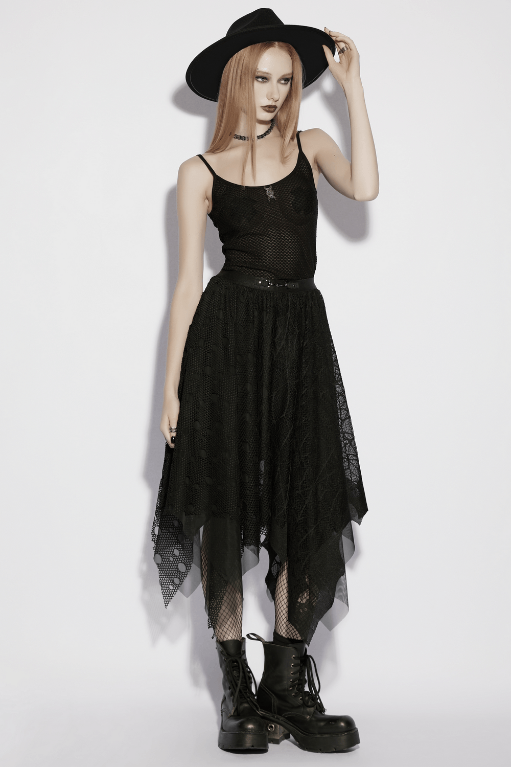 Alt Tag: Black Gothic Mesh Camisole with Moon Charm Detail on model with black witch hat, layered sheer skirt, and combat boots