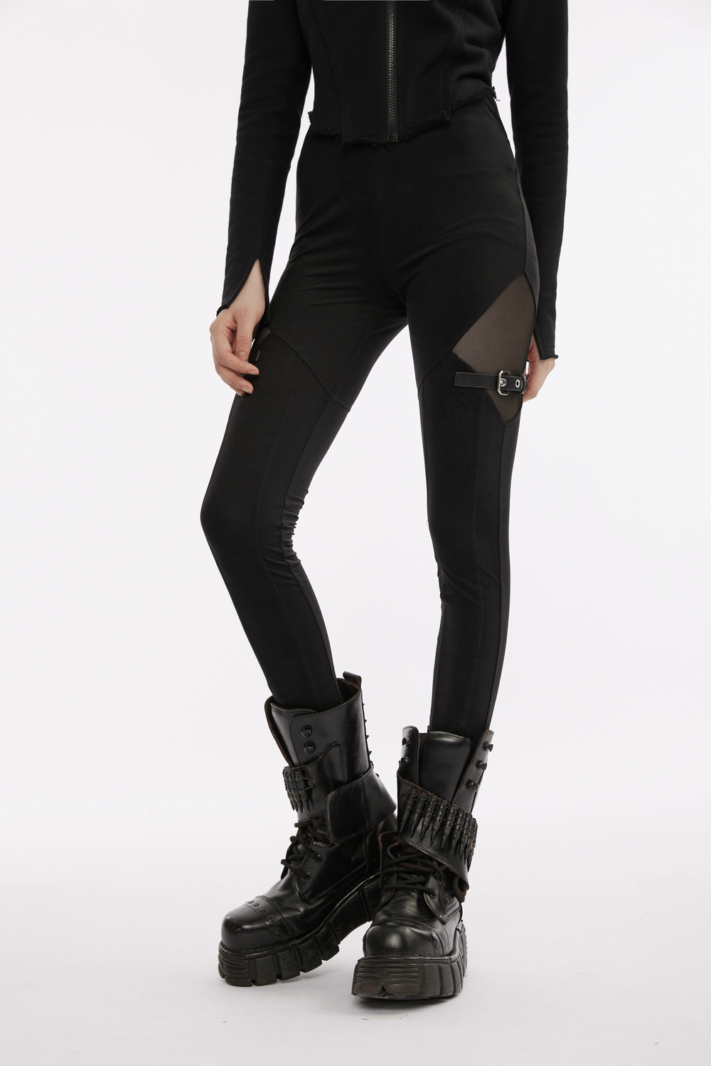 Black gothic leggings with mesh panels and buckle accents, paired with edgy platform boots for a punk-inspired look.