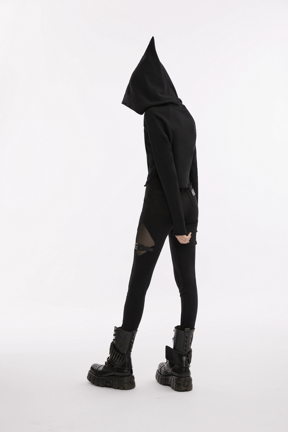 Model showcasing black gothic mesh-panel leggings with buckle accents, styled with edgy punk footwear and a hooded top.